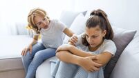 Mature woman consoling her daughter